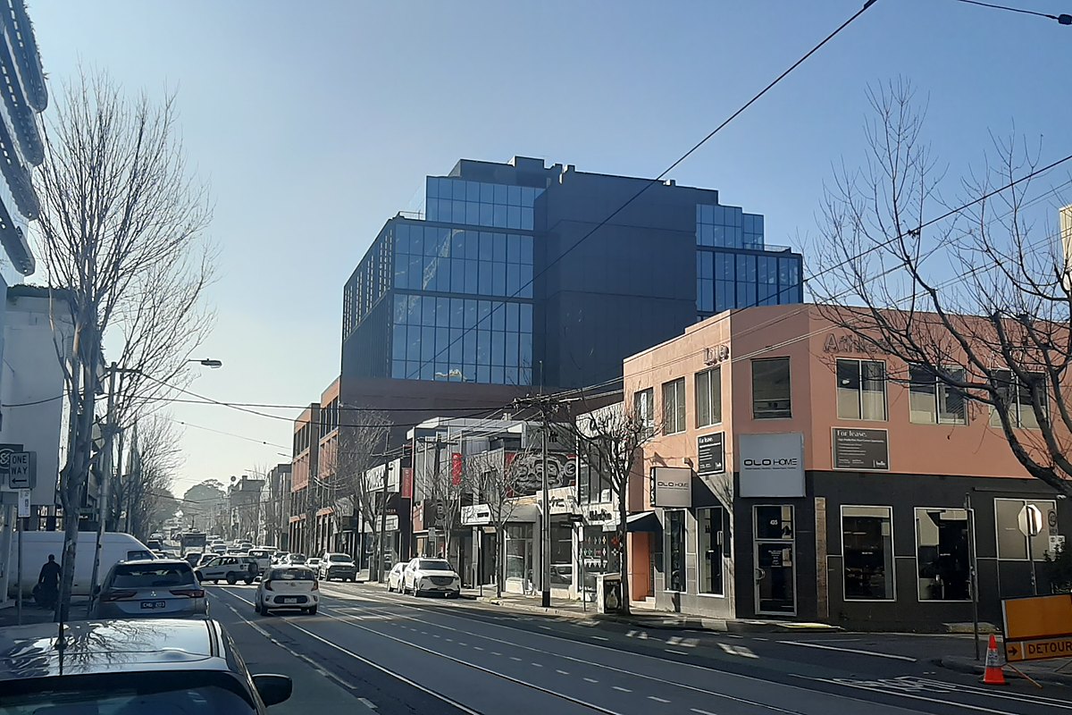 Modern glass office building and shops on Church Street in Cremorne, Melbourne