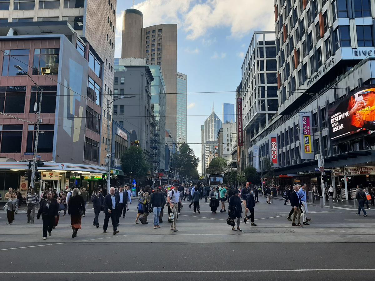 Pedestrians crossing at the corner of Flinders Street and Elizabeth Street in the Melbourne CBD