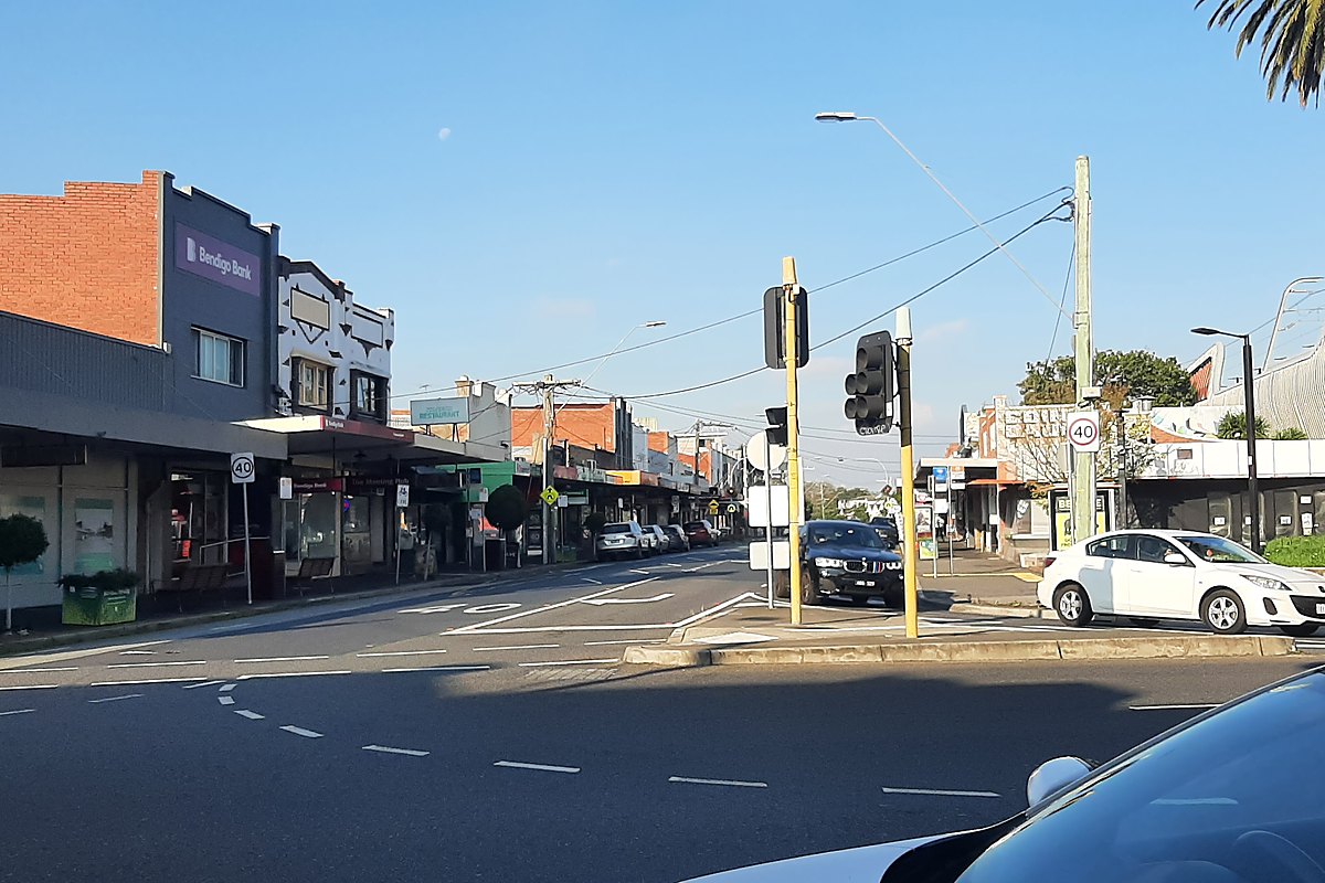 Shops and palm trees along Murrumbeena Road in Murrumbeena, Melbourne