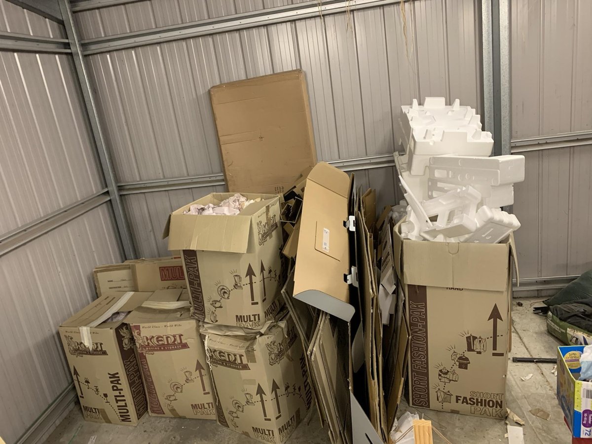 Boxes and cardboard packaging stacked in a shed ready for removal
