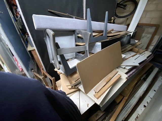 Old shelving, timber and mixed clutter cleared from a shed