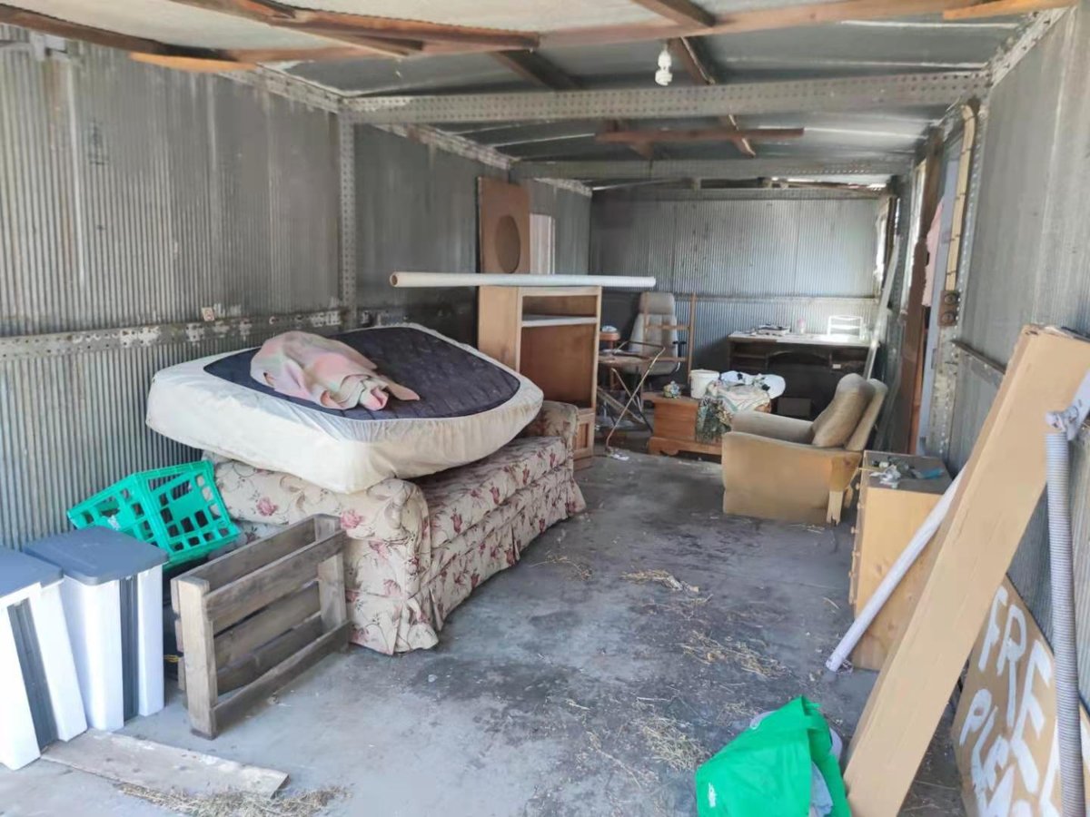 Shed interior cleared of an old mattress, couch and set of drawers during a Melbourne cleanout