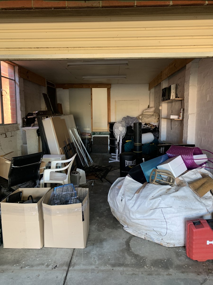 Garage packed wall to wall with boxes and bags before an It's Done cleanout