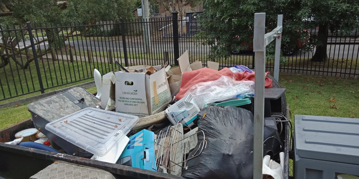 Trailer loaded with mixed household rubbish and an old mattress during an It's Done clearout