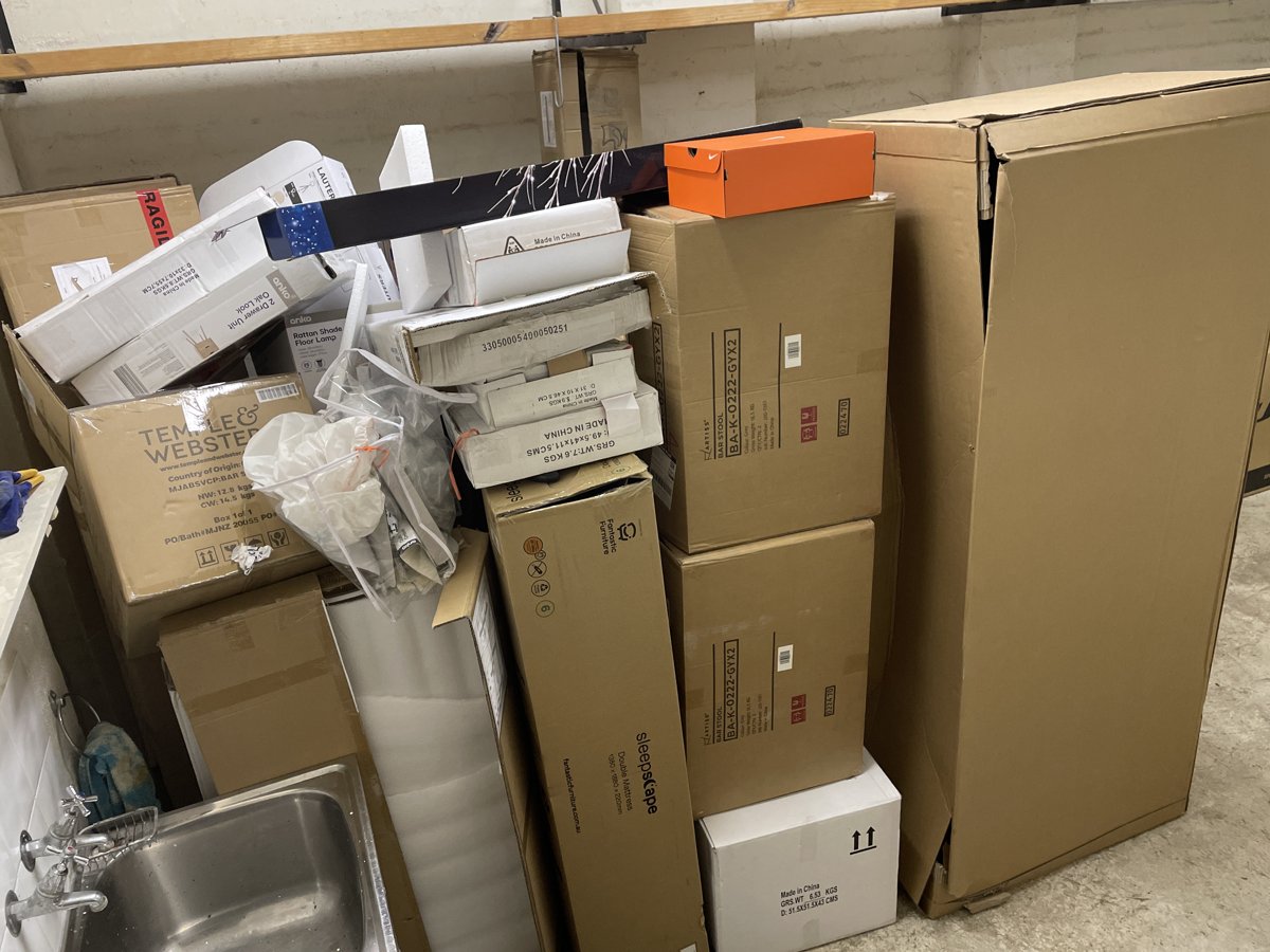 Boxes, office equipment and a sink unit cleared from an office fit-out