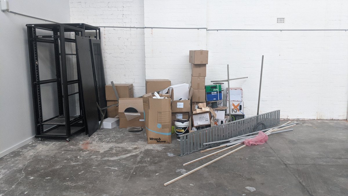 Metal shelving frames and office clutter cleared from a commercial space